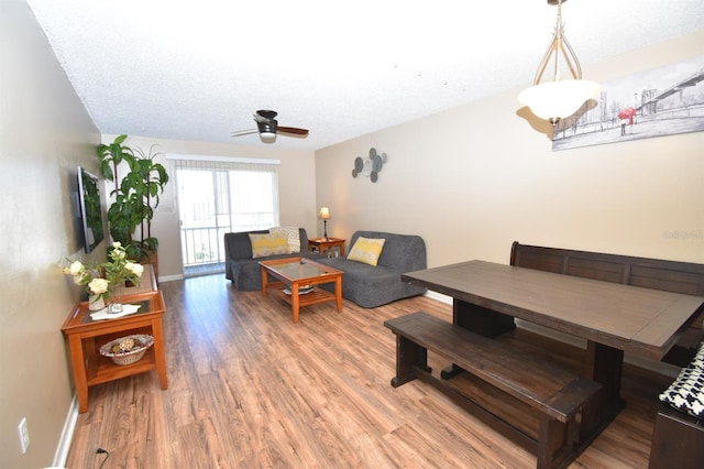 living room featuring ceiling fan and wood-type flooring