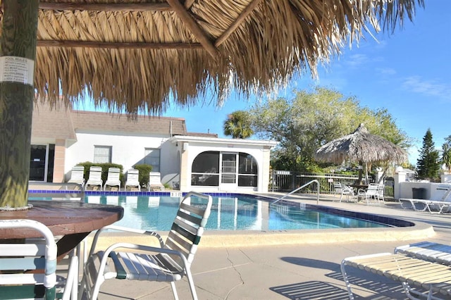 view of pool featuring a sunroom and a patio