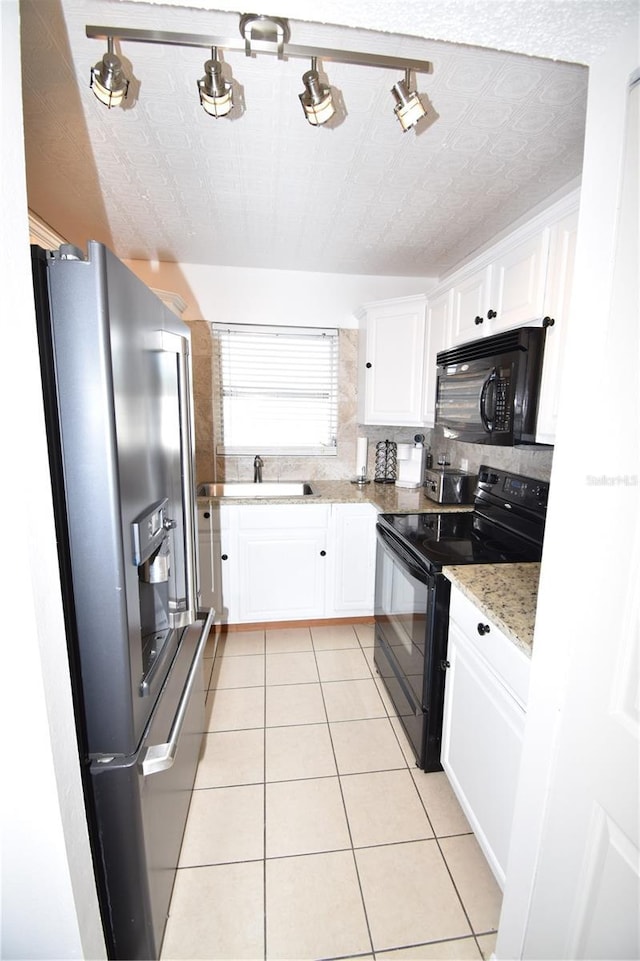 207 S Mcmullen Booth Rd Unit 198, Clearwater, FL 33759 - kitchen featuring white cabinets, light tile patterned floors, a sink, and black appliances