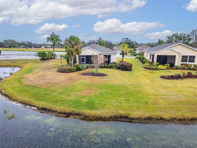 view of front facade with a water view and a front yard