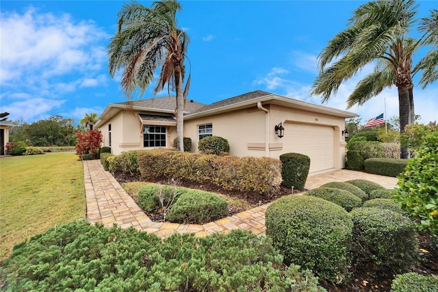 ranch-style home featuring a garage and a front lawn