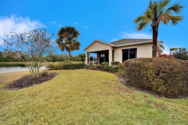 view of front facade featuring a water view and a front yard