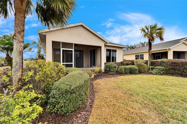 view of front of property with a front lawn and a sunroom