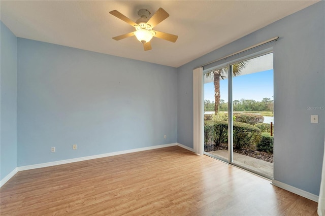 spare room featuring light hardwood / wood-style floors and ceiling fan