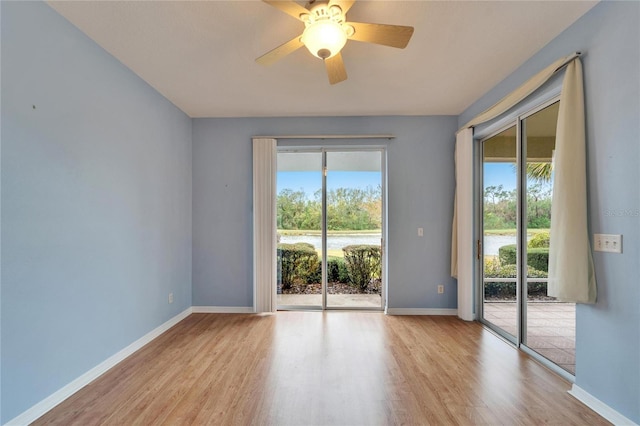 unfurnished room with ceiling fan and light wood-type flooring