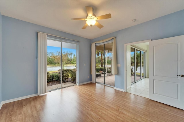 unfurnished room featuring ceiling fan and light hardwood / wood-style floors