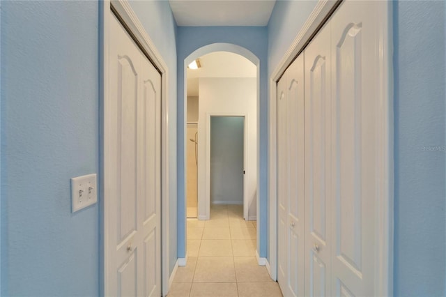 hallway with light tile patterned floors