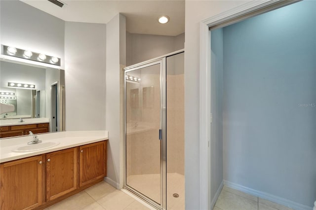 bathroom featuring vanity, tile patterned floors, and walk in shower