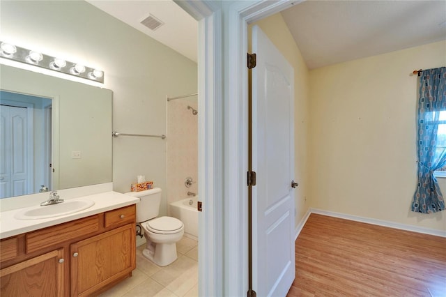 full bathroom featuring tiled shower / bath combo, vanity, tile patterned flooring, and toilet