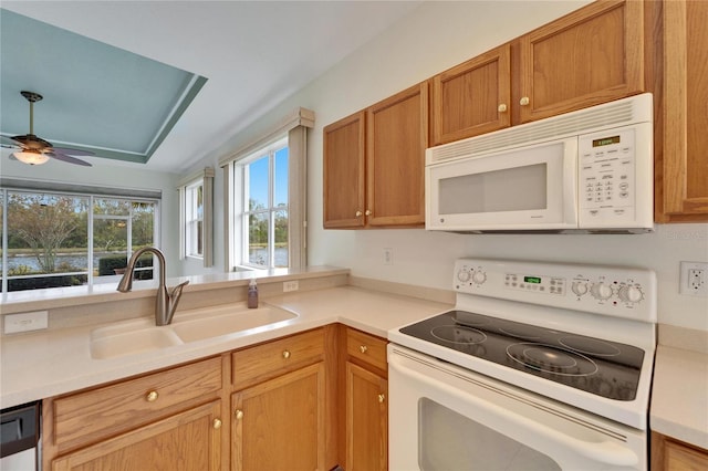 kitchen with ceiling fan, white appliances, and sink