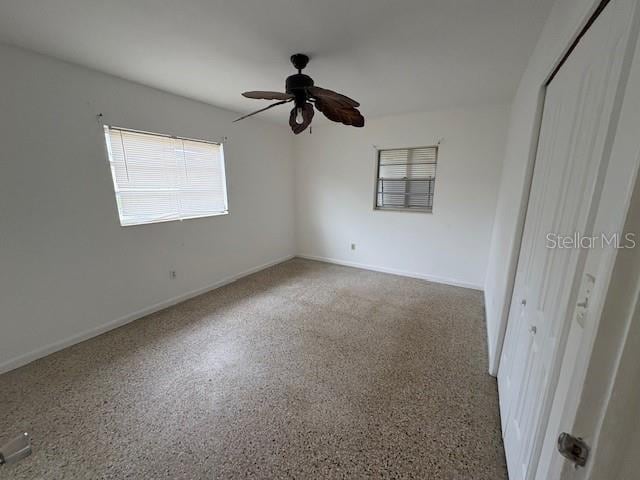 unfurnished bedroom featuring ceiling fan