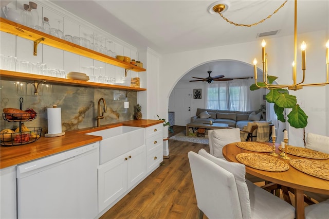 kitchen featuring ceiling fan, sink, white dishwasher, white cabinets, and wood counters