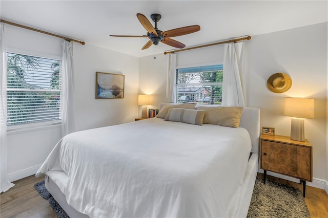 bedroom with ceiling fan and light hardwood / wood-style floors