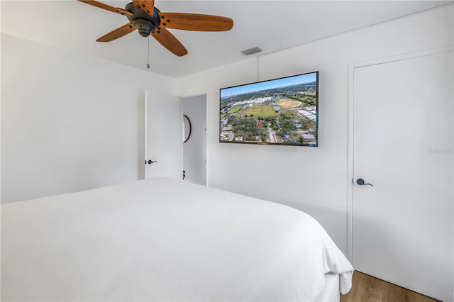 bedroom featuring ceiling fan and dark hardwood / wood-style flooring