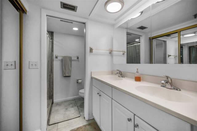 bathroom with tile patterned floors, walk in shower, vanity, and toilet