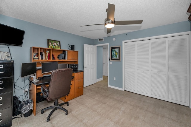 office with ceiling fan and a textured ceiling