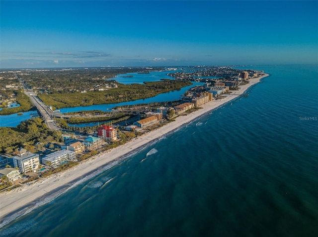 birds eye view of property with a water view and a beach view