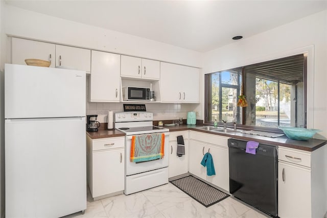 kitchen with white appliances, sink, decorative backsplash, and white cabinets