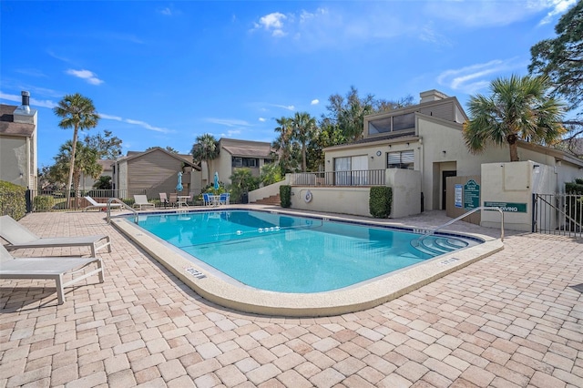 pool featuring a patio and fence