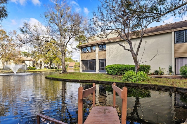 dock area featuring a yard and a water view