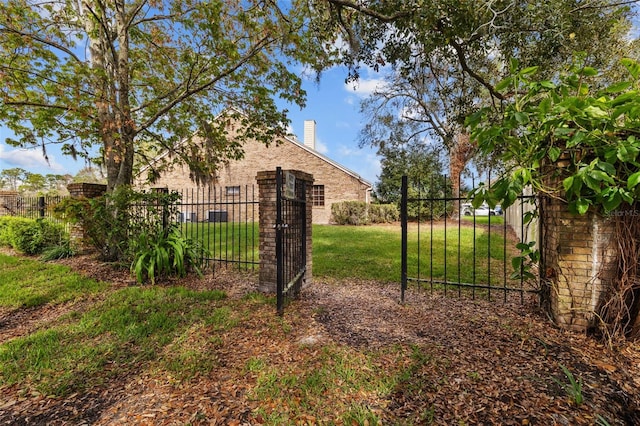 view of gate featuring fence and a yard