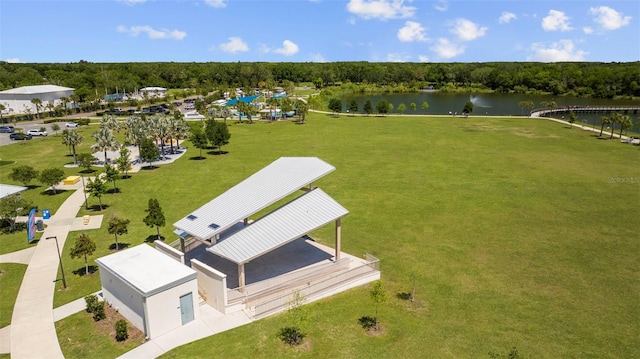 drone / aerial view with a water view and a wooded view