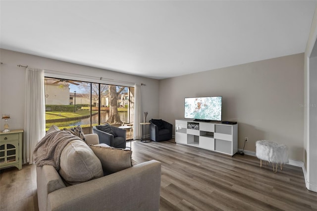 living room featuring wood finished floors and baseboards