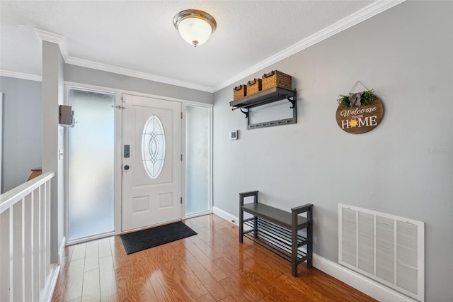 entryway featuring crown molding and hardwood / wood-style flooring