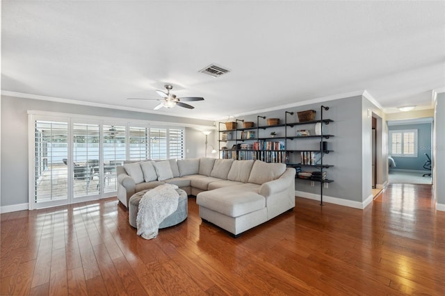 living room featuring ceiling fan, ornamental molding, and hardwood / wood-style floors