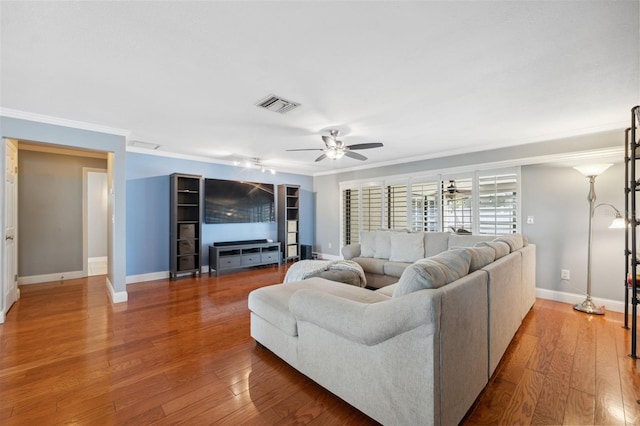 living room featuring ceiling fan, wood-type flooring, and ornamental molding