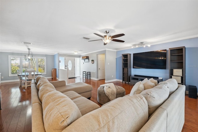 living room featuring ceiling fan, dark hardwood / wood-style floors, and crown molding