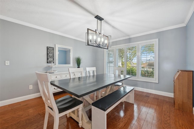 dining room featuring a chandelier, crown molding, and dark hardwood / wood-style floors