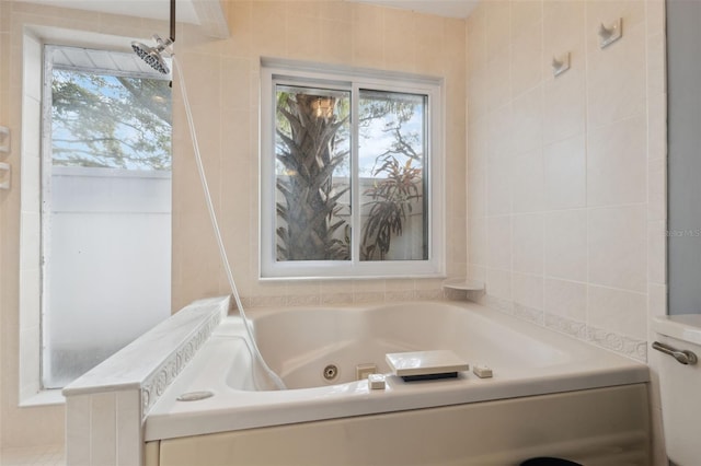 bathroom with tile walls and a tub