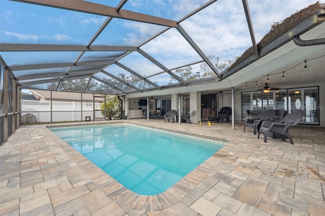 view of pool featuring a patio area, a lanai, and ceiling fan