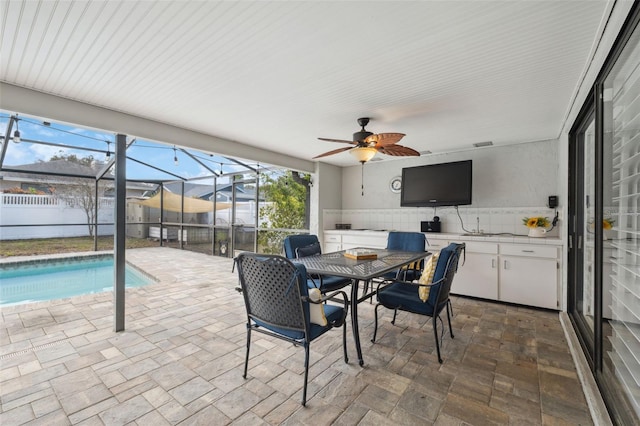 sunroom featuring ceiling fan