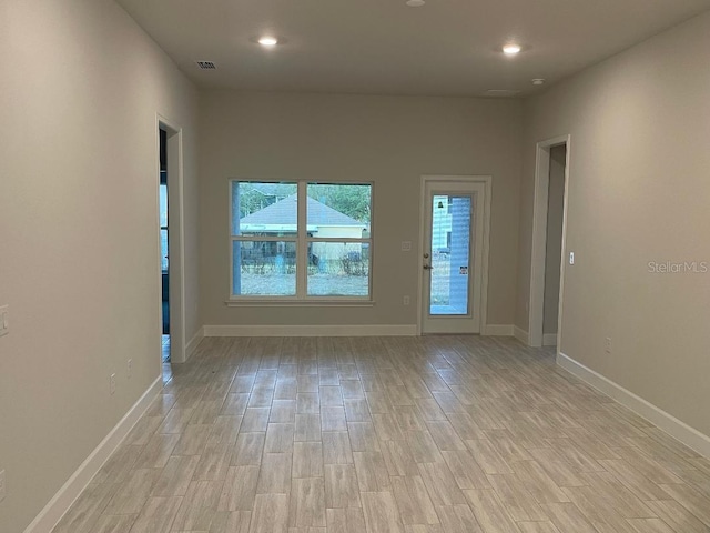 empty room with light hardwood / wood-style flooring