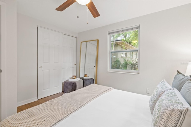 bedroom featuring ceiling fan, wood-type flooring, and a closet