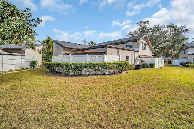 back of property featuring a pool and a yard