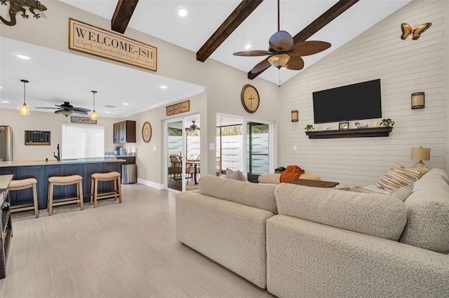 living room with ceiling fan, sink, high vaulted ceiling, and beam ceiling