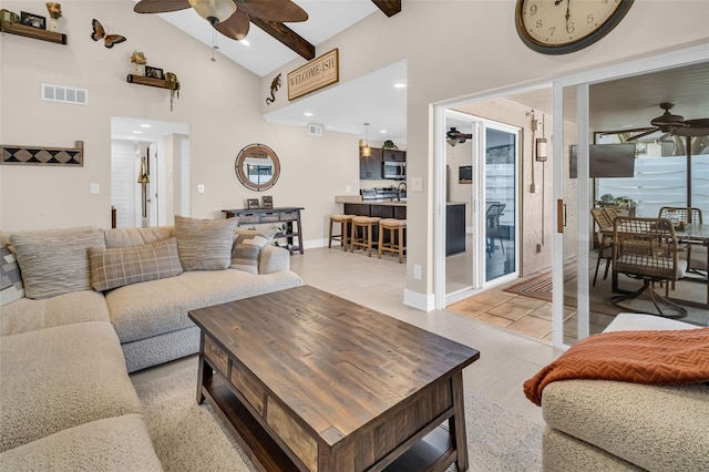 living room featuring ceiling fan and vaulted ceiling with beams