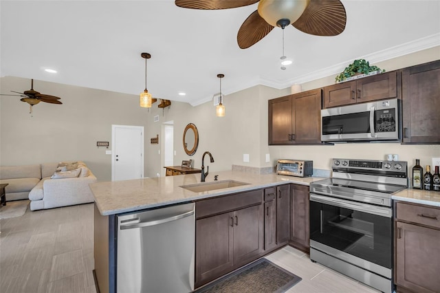 kitchen featuring hanging light fixtures, kitchen peninsula, sink, and stainless steel appliances