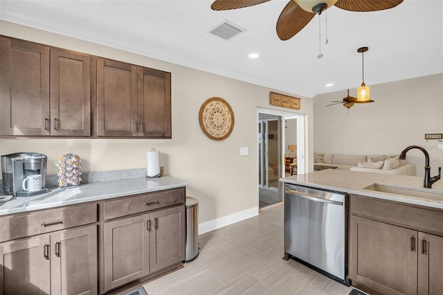 kitchen with pendant lighting, stainless steel dishwasher, sink, dark brown cabinetry, and light stone counters