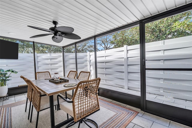 sunroom featuring ceiling fan and plenty of natural light