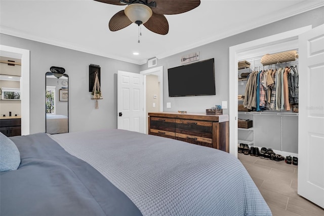 bedroom with ceiling fan, a closet, and crown molding