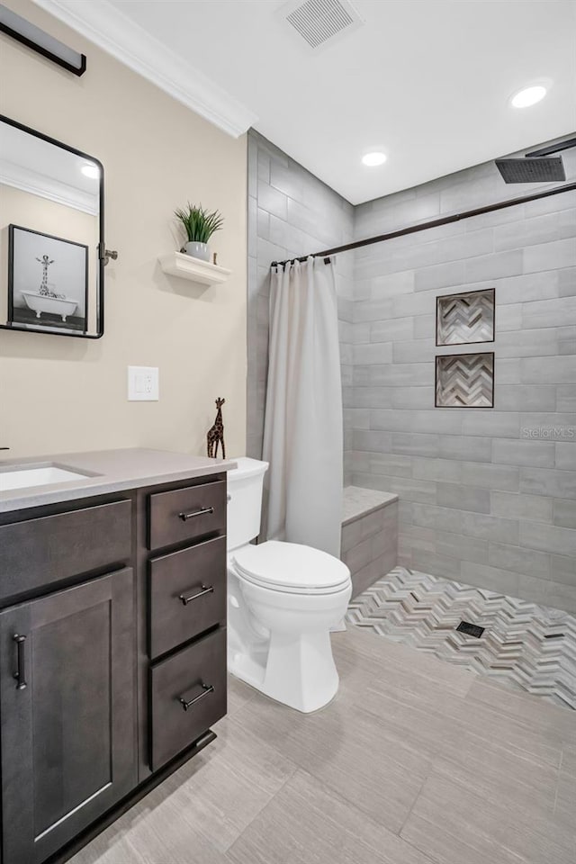 bathroom with toilet, ornamental molding, a shower with curtain, and vanity