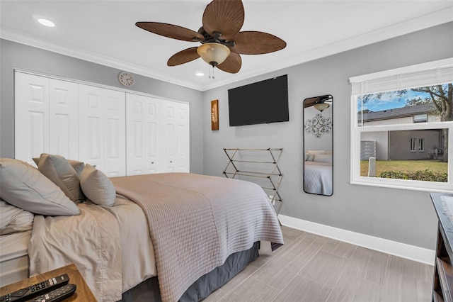 bedroom featuring crown molding, ceiling fan, a closet, and multiple windows