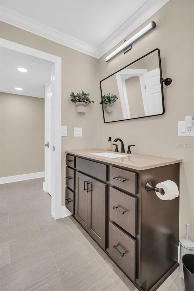 bathroom with vanity, tile patterned floors, and crown molding