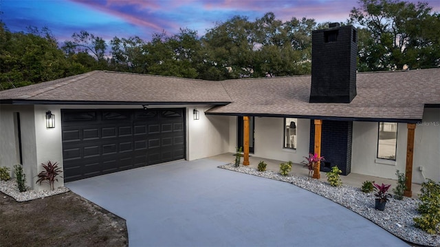 view of front of house featuring covered porch and a garage