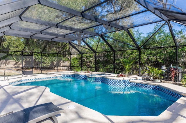 view of pool featuring a lanai, a patio area, and an in ground hot tub