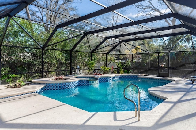 view of pool with a lanai, a patio, and an in ground hot tub